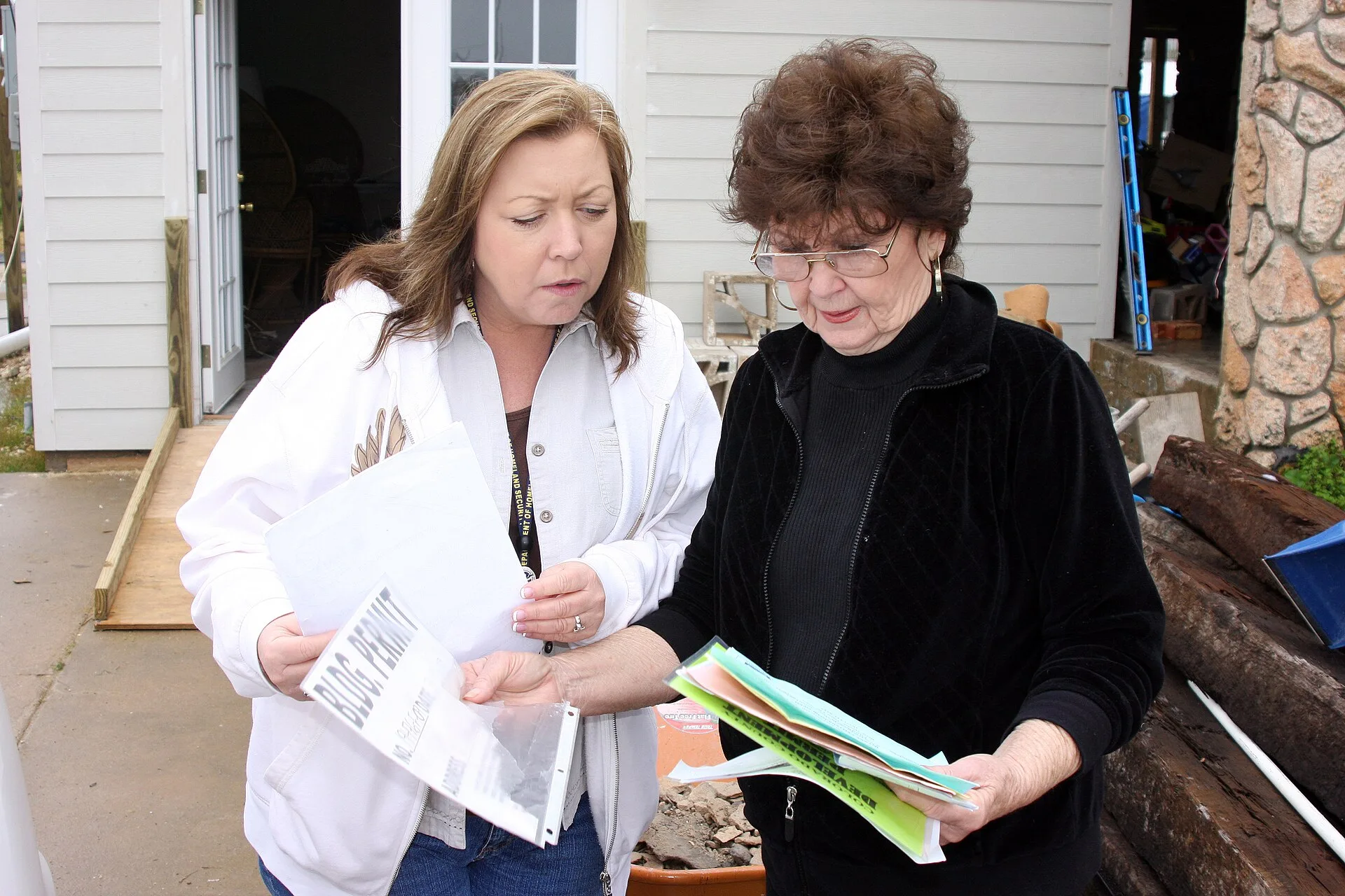 Hitchcock, TX, January 20, 2010 -- FEMA Individual Assistance Applicant Services Specialist Lisa Jackson reviews paperwork with Barbara Dowden regarding her recent purchase of the temporary housing unit FEMA provided to the Dowdens for use as they made repairs to their Hurricane Ike damaged home. Th. Lease Administration Outsourcing for Small Landlords: Who Does What